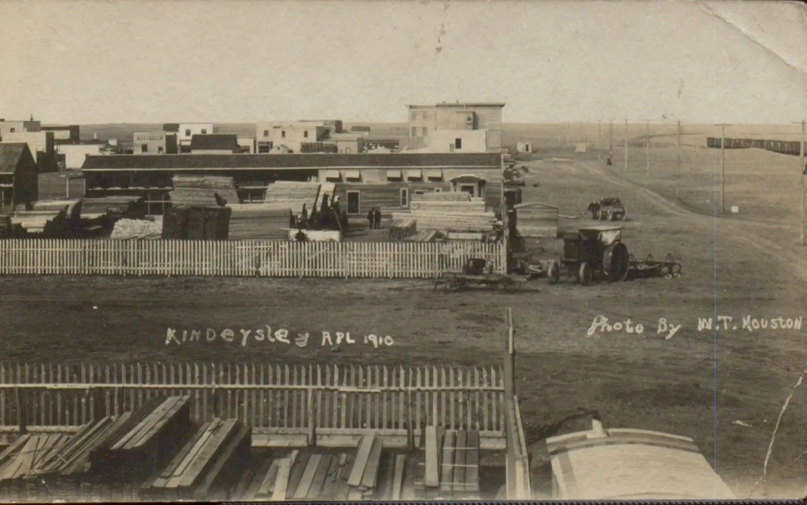 Kindersley town site with lumber yard and tractor, April 1910